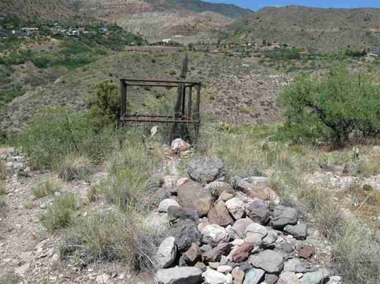 Insert 16. 2 unknown graves with mine tailings in background.jpg